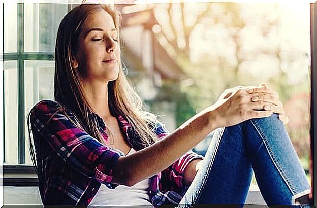 girl at the window with closed eyes symbolizing how Buddhism to face chaos