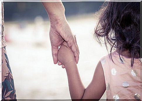 Mother holding her daughter by the hand