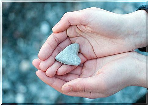 Hands with a heart of stone to represent affective relationships