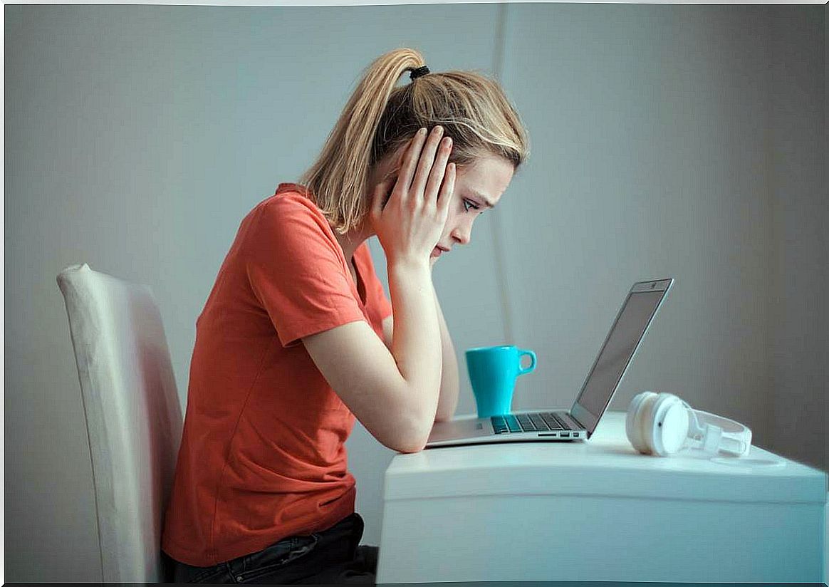 Girl at the computer suffering from anxiety and concentration problems