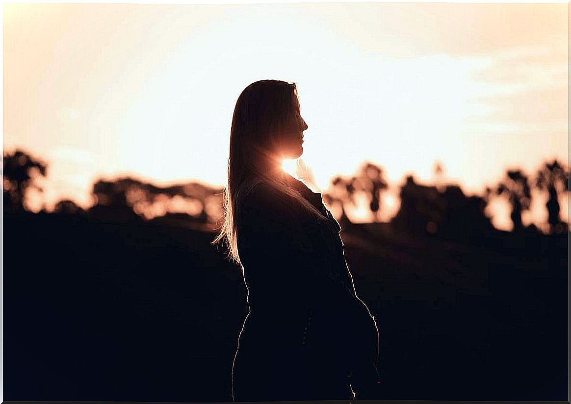 Girl at sunset thinking about the relationship of anxiety and immune system