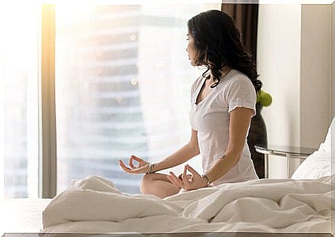 Woman doing mindfulness in her bedroom