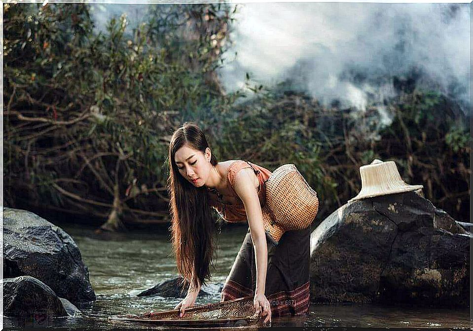 Woman at the lake thinking about gray clouds