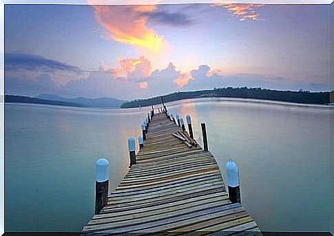 pier in lake symbolizing the text "It's called calm", by the Dalai Lama