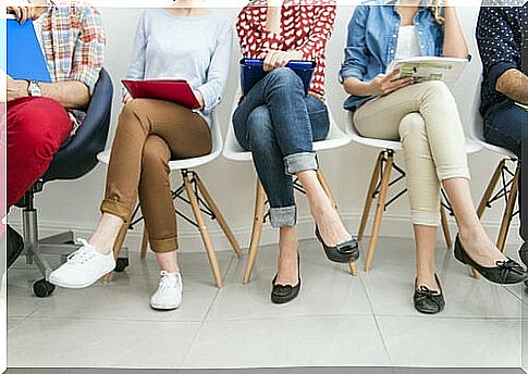 Unemployed people sitting in chairs attending training