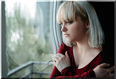 Blond woman looking out the window