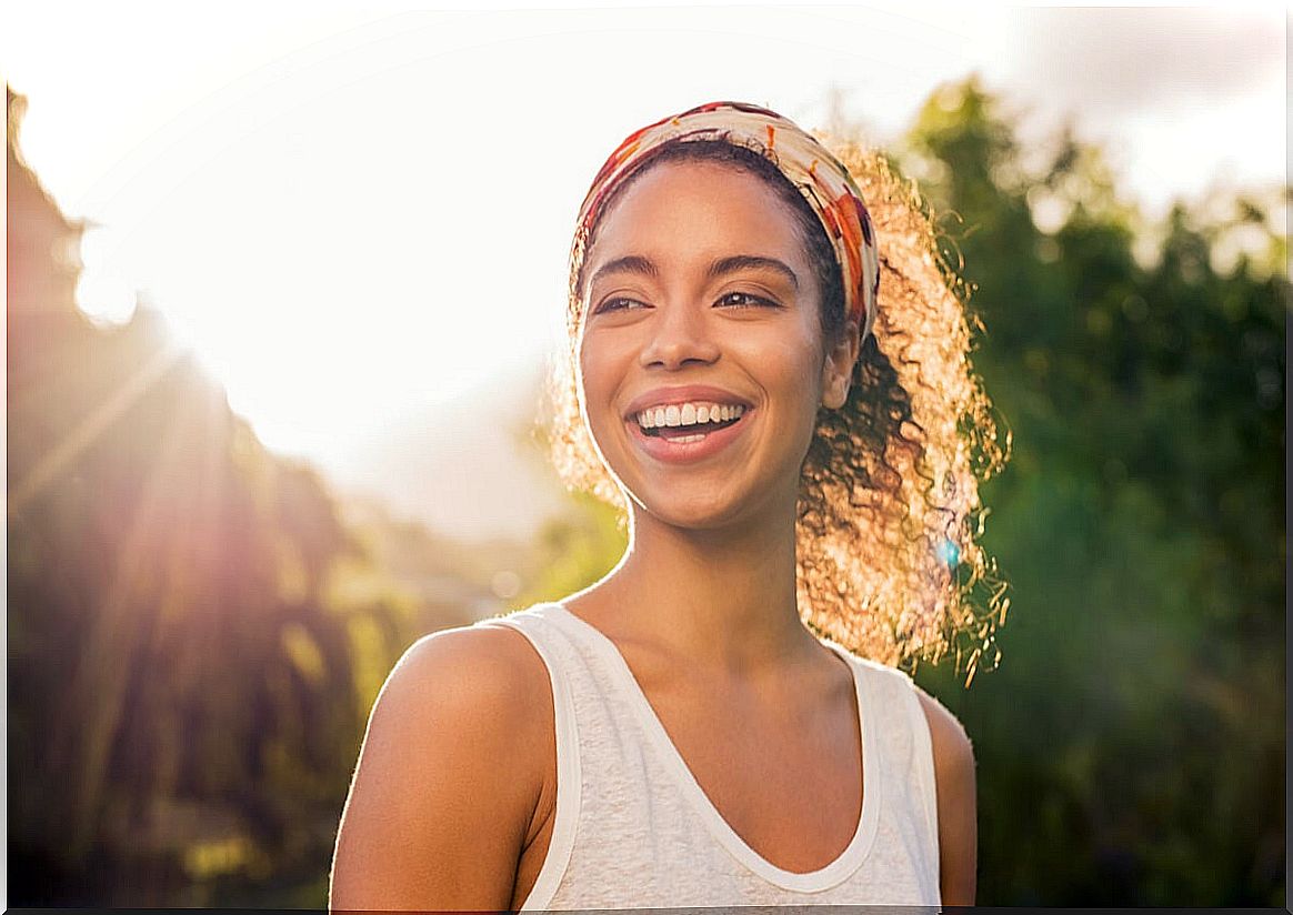 Happy woman smiling wondering if we are born optimistic