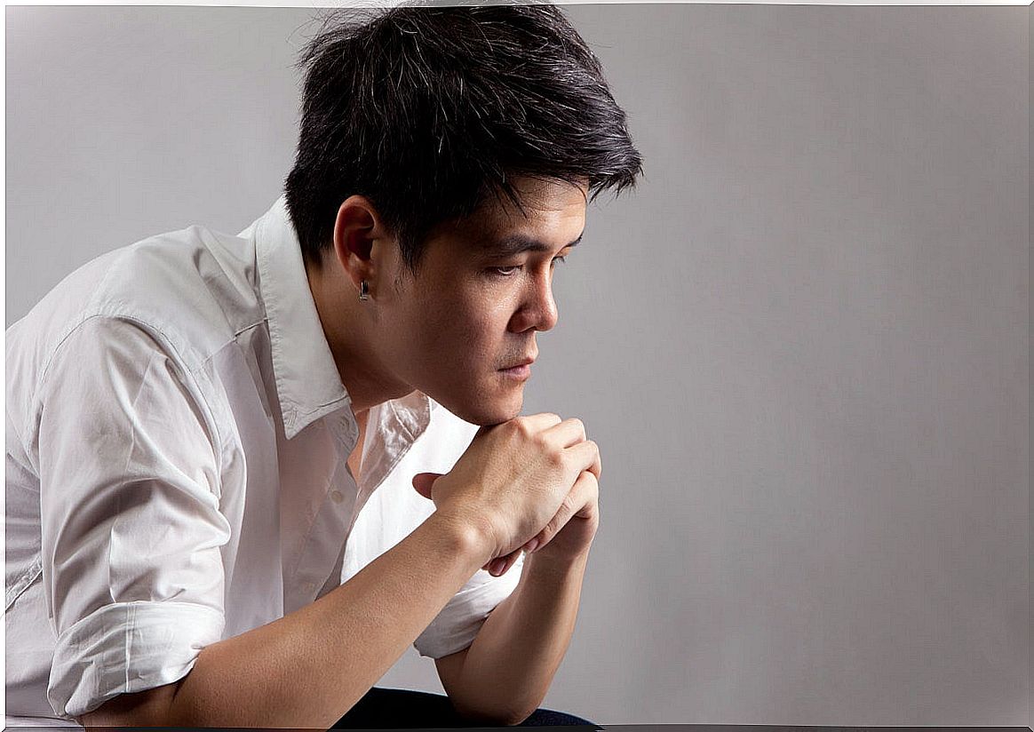 Young Japanese man stressed and isolated