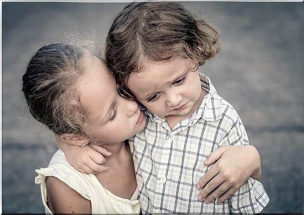 Older sister comforting her little sister