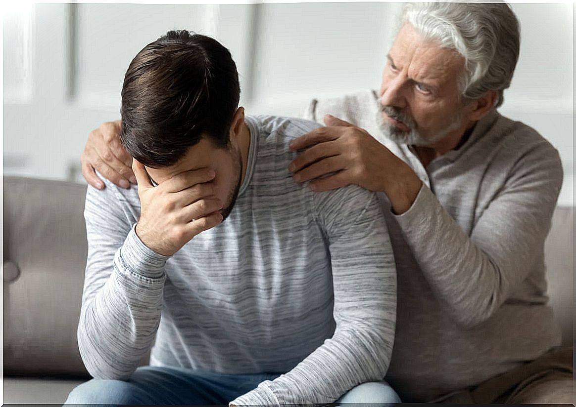 Father comforting his son with disorganized thinking and communication problems