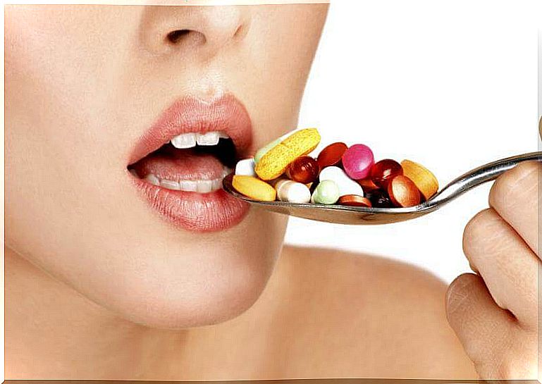 Woman about to eat a spoonful of pills